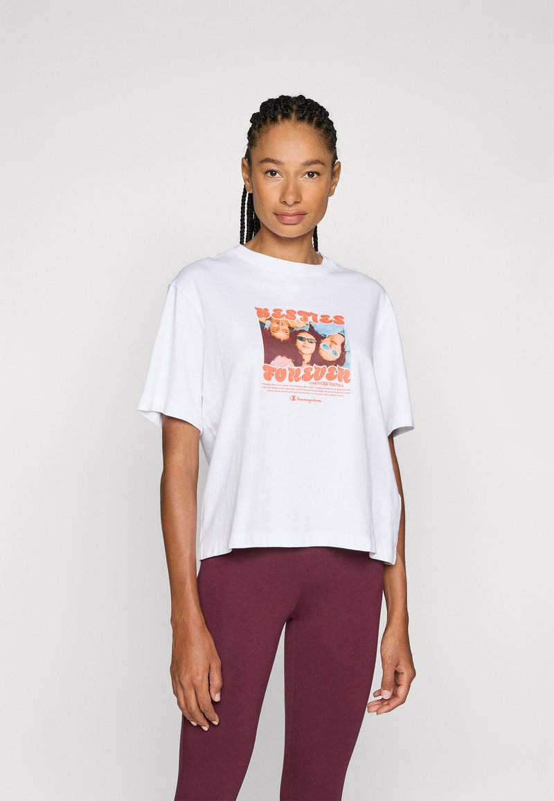 White cotton t-shirt with short sleeves and a loose fit. Features a colorful graphic print that says “Besties Forever” on the front.