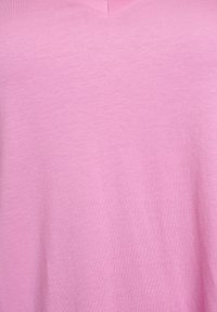 Pink v-neck t-shirt made of soft cotton blend fabric. Features a smooth texture and simplicity in design, suitable for casual wear.