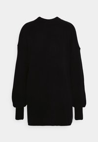 Pull noir oversize en maille avec manches longues, poignets côtelés et encolure ronde. Texture lisse, design minimaliste, sans motifs visibles.