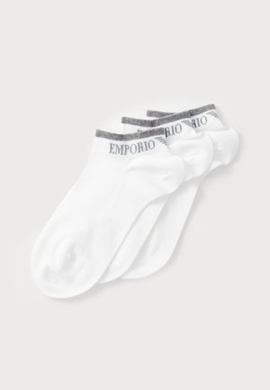 White ankle socks in a pack of four, featuring a grey-striped cuff with "Emporio" logo. Material appears smooth with slight stretch.