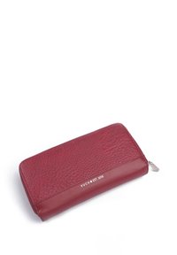 Red leather wallet with a textured finish and smooth accents. Features a zipper closure and embossed brand name.
