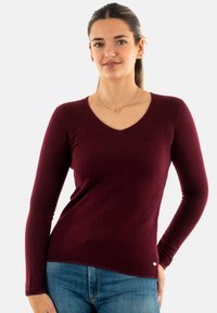 Maglione bordeaux a maniche lunghe con scollo a V in tessuto morbido, caratterizzato da un design aderente e sottili dettagli testurizzati all'orlo e ai polsini.