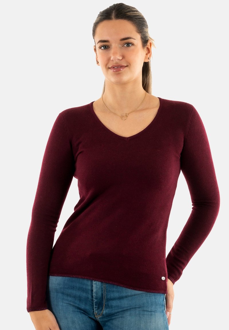 Maglione bordeaux a maniche lunghe con scollo a V in tessuto morbido, caratterizzato da un design aderente e sottili dettagli testurizzati all'orlo e ai polsini.