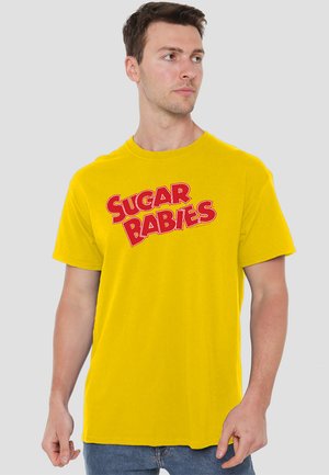 Yellow cotton t-shirt featuring bold red "SUGAR BABIES" text in a playful font. Short sleeves, crew neck, and casual fit.