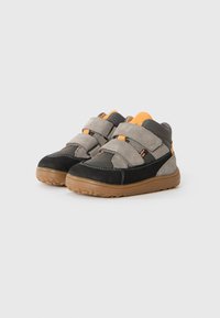Pair of gray, black, and orange children's sneakers with two Velcro straps and brown rubber soles on a white background.