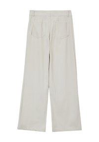 Pantaloni in corda beige a gamba ampia con superficie testurizzata, dotati di tasche posteriori e una vita regolare, progettati per un fit rilassato.
