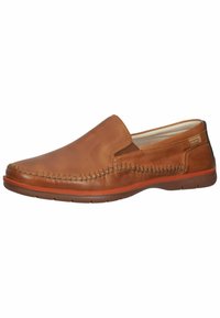 Zapato marrón de cuero sin cordones con detalles de costura, punta redonda y suela de goma naranja. Superficie superior suave con un diseño minimalista.