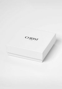 Weiße rechteckige Geschenkbox mit glatter Oberfläche und einem schwarzen Logo "CHRIST seit 1863", das mittig auf dem Deckel platziert ist. Verfügt über ein einfaches, elegantes Design.