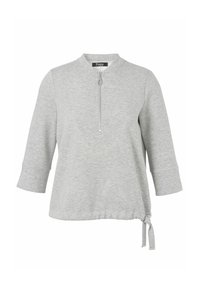 Lichtgrijze longsleeve top met een kwart ritssluiting, ronde halslijn en verstelbaar trekkoord aan de onderkant.
