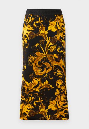 Black skirt featuring a vibrant gold floral pattern, crafted from soft fabric, with an elastic black waistband showing brand logo.