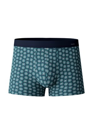 Herenboxers met een marineblauwe tailleband, met een teal achtergrond en een herhalend hexagonaal patroon in wit en donkerder teal.