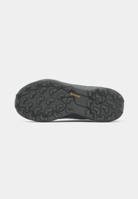 Black sneaker sole with prominent grip patterns and tread design. Features "Continental" branding in orange. Durable rubber material.