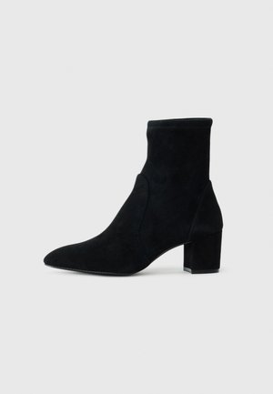 Black suede ankle boot with a pointed toe, mid-height block heel, and elasticized shaft. Smooth texture with no visible hardware or accents.