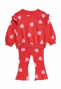 Rød sweatshirt med pink smilende hjerter, har flæseærmer og ribbede manchetter. Matchende ribbede leggings med hjerte-mønstre.