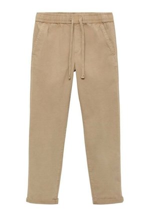 Beige cotton jogger pants with an elastic waistband, drawstring, and side pockets. Tapered leg design with rolled cuffs.