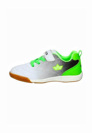 Footwear features a white and gray synthetic upper, green laces, and a rubber sole with a textured pattern. Notable green accents on heel.