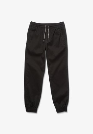 Zwarte joggings met een elastische tailleband en verstelbaar trekkoord. Voorzien van ribbels aan de cuffs en zijzakken. Soepele stoftextuur.