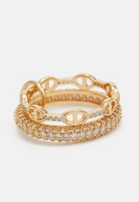 Gold-tone ring set featuring three rings: one with clear stones, one with oval links, and another with a beaded texture.