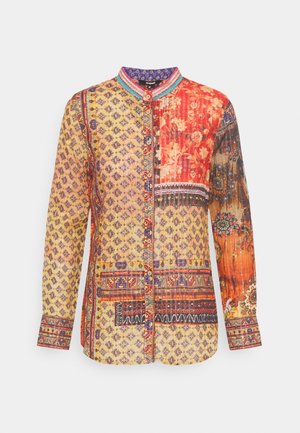 Long-sleeve buttoned shirt with mixed floral, geometric, and ornamental patterns in yellow, red, orange, and blue tones.