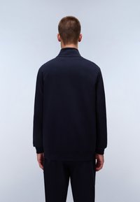 Navy blue sweatshirt with a high collar, ribbed cuffs, and hem, shown from the back on a plain background. Soft texture, minimal design.