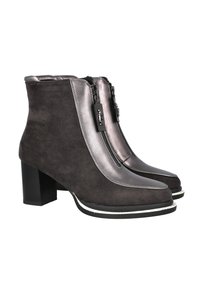 Botines de ante gris con detalles metálicos, dos cremalleras frontales, tacón grueso y un ribete blanco contrastante a lo largo de la suela.