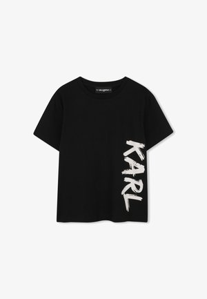 T-shirt nera a maniche corte per bambini con testo verticale bianco "KARL" sul lato destro e scollo rotondo.