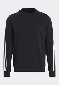Felpa nera con scollo rotondo e maniche lunghe a raglan. Presenta tre strisce bianche lungo le maniche e polsini a costine.