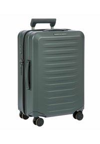 Valigia rigida grigia con superficie texturizzata, scanalature verticali, manico telescopico, doppia cerniera e quattro ruote girevoli.