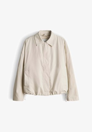 Hellbeige Jacke mit Kragen, Frontreißverschluss, Seitentaschen und elastischem Saum. Hergestellt aus glattem Stoff mit leicht matter Oberfläche.
