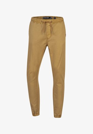 Kaki joggebukser med elastisk liv, snøring, innsnevrede ben og manchetter ved anklene. Myk bomullsblanding.
