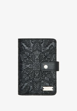 Black wallet with embossed floral pattern, magnetic snap closure, and a metallic "ROXY" plate. Compact rectangular shape with textured finish.