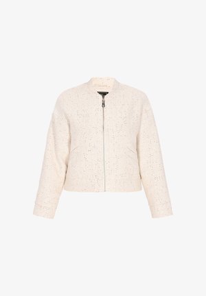 Lühendatud pommijakk tekstureeritud kreemjas kangas, kus on läikivad niidid. Omab eesmist tõmblukku, ümarat kaelust ja küljetaskuid.