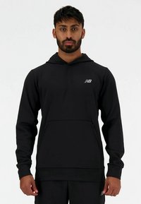 Zwarte New Balance hoodie met capuchon, lange mouwen, zak aan de voorkant en een subtiel logo op de borst. Glad stof en sportieve pasvorm.