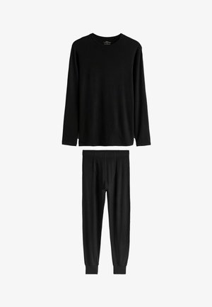 Czarna bluzka z długim rękawem i dopasowane spodnie wykonane z gładkiego materiału. Bluzka ma okrągły dekolt; spodnie wyposażone są w elastyczną talię i mankiety.