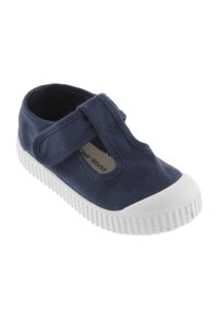 Scarpa in tela blu navy con punta rotonda in gomma bianca, cinturino regolabile in Velcro e suola in gomma testurizzata, progettata per il comfort e la stabilità.