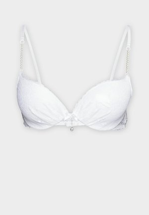 Soutien-gorge en dentelle blanche avec un décolleté plongeant, doté de bretelles ajustables avec un accent en perles et un charme décoratif au centre.