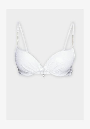 Soutien-gorge en dentelle blanche avec un décolleté plongeant, doté de bretelles ajustables avec un accent en perles et un charme décoratif au centre.
