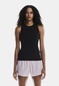 Black sleeveless athletic top with a high neckline, paired with light pink shorts. Smooth fabric, fitted design, no visible logos or patterns.