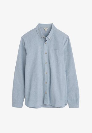 Heled sinine chambray-särk, millel on pikad varrukad, nöödiga esikülg ja üks rinna tasku. Omab klassikalist kraed ja sirget allääret.
