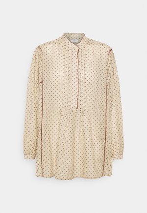 Langärmlige cremefarbene Bluse mit braunen Punkten, geknöpften Ausschnitt und Falten-Details. Weiches Material mit gewellten Kantenakzenten.