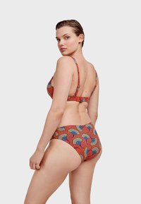 Ensemble de bikini en tissu rouge avec un motif de ventilateur coloré, bretelles ajustables et un design de dos plongeant. Convient pour la natation.