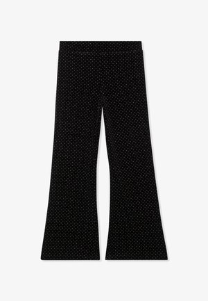 Pantaloni a gamba larga in velluto nero con piccoli pois bianchi e una vita aderente, mostrati stesi su uno sfondo bianco.