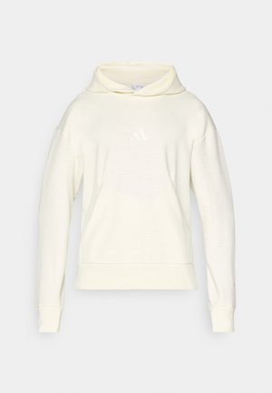 Svijetložuti pulover s kapuljačom, s teksturiranim uzorkom, visokom ovratniku, dugim rukavima i malim bijelim logotipom na prsima. Mekani završetak tkanine.