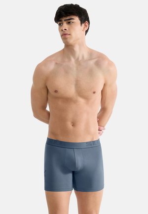 Grau melierte Boxershorts mit glatter Textur, elastischem Bund mit geprägtem Logo und figurbetontem Schnitt. Geeignet für den Freizeitlook.