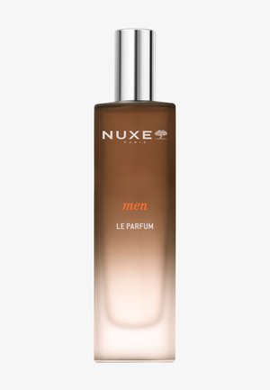 Nuxe Herrenparfum in einer rechteckigen Glasflasche mit einem silbernen Deckel. Die Flasche weist einen Farbverlauf von Braun zu Klar auf und hat weißen Text.