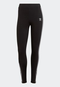 Svarta leggings i stretchmaterial, med hög midja, vertikala vita ränder på sidorna och en Adidas-logga på vänster höft.