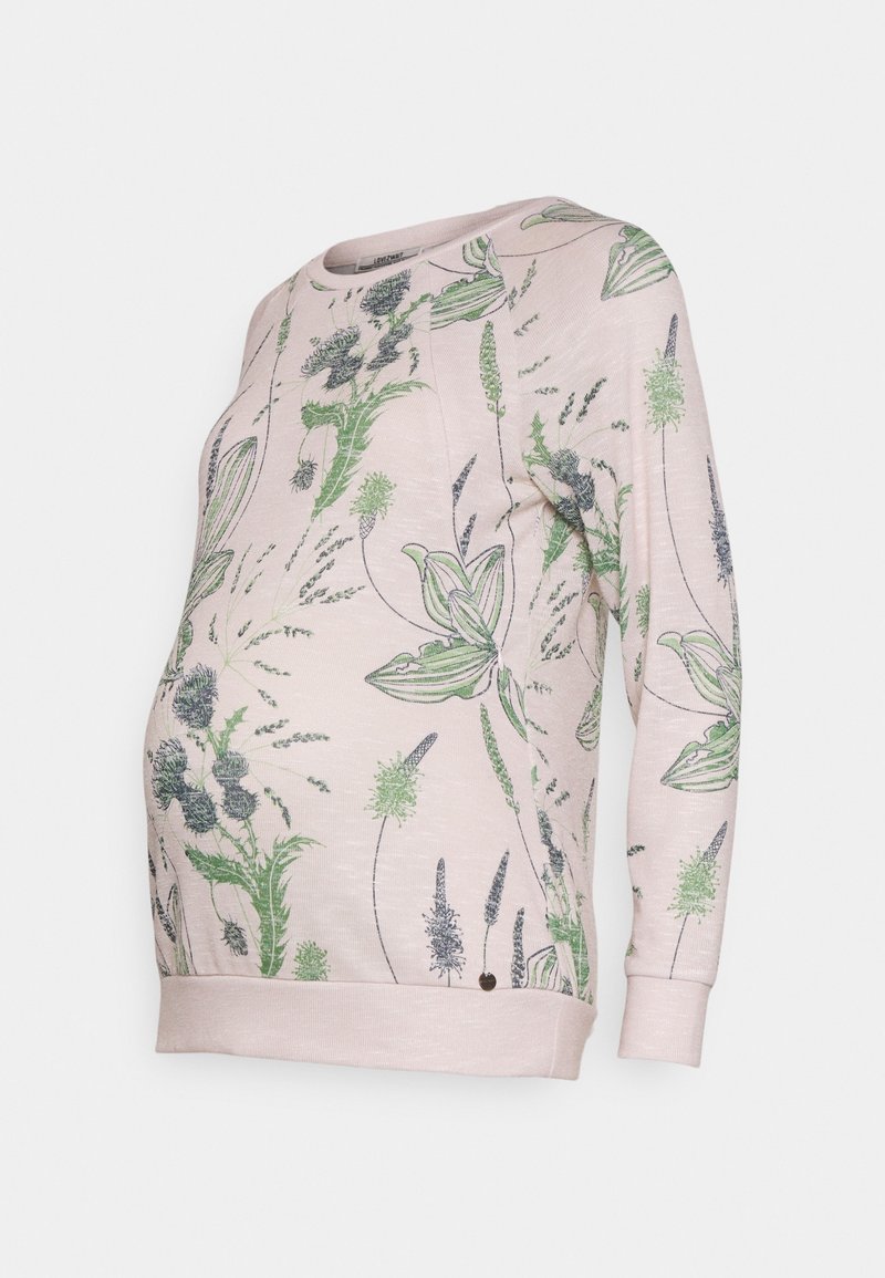 Sweat-shirt de maternité en tissu rose clair avec motifs floraux verts et noirs. Il présente un col rond et des manches longues avec des bords côtelés.