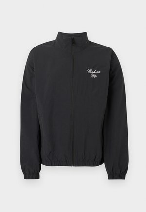 Veste noire zippée avec poignets et ourlet élastiques, arborant le logo blanc "Carhartt Wip" sur le côté gauche de la poitrine.