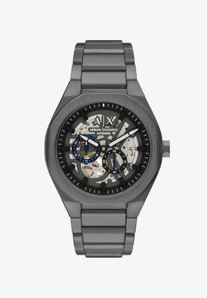 Automatisch Armani Exchange horloge in kanonslaggrijs met skeletten wijzerplaat, blauwe en zwarte subwijzerplaten en metalen schakelarmband.