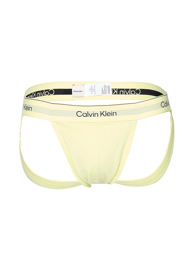 Helle gelbe Jockstrap-Unterwäsche für Herren von Calvin Klein mit Logo am Bund und angenähtem Pflegeetikett.